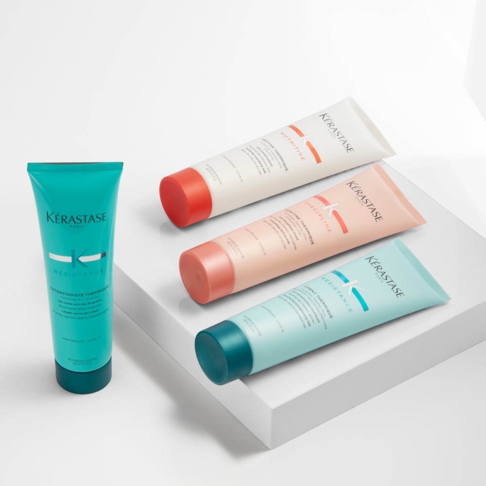  Kérastase Nutritive, Discipline and Resistance Thermiques are displayed on a simple grey platform around a pure grey background.